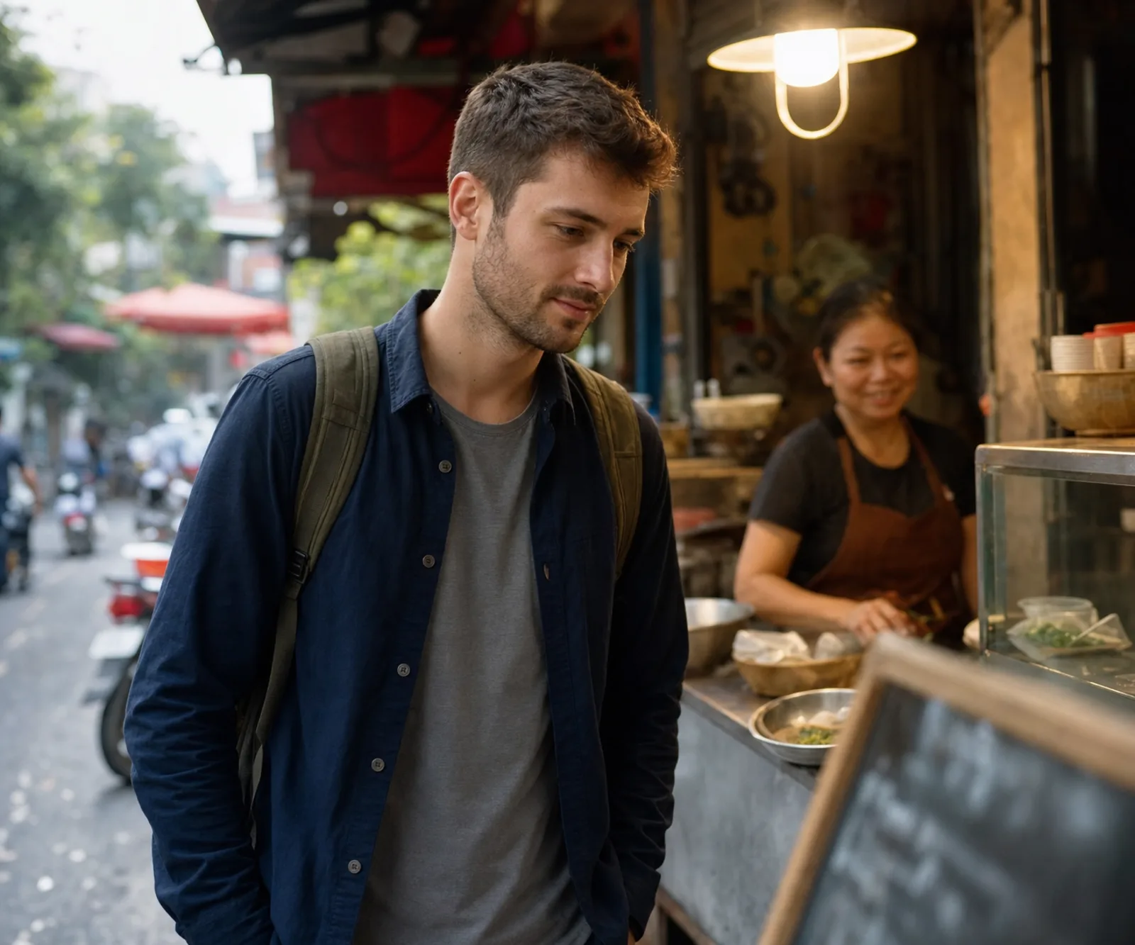 the traveller reads a menu chalked on the slate of a Hanoi food stall; Vietnamese letters and accents clearly visible